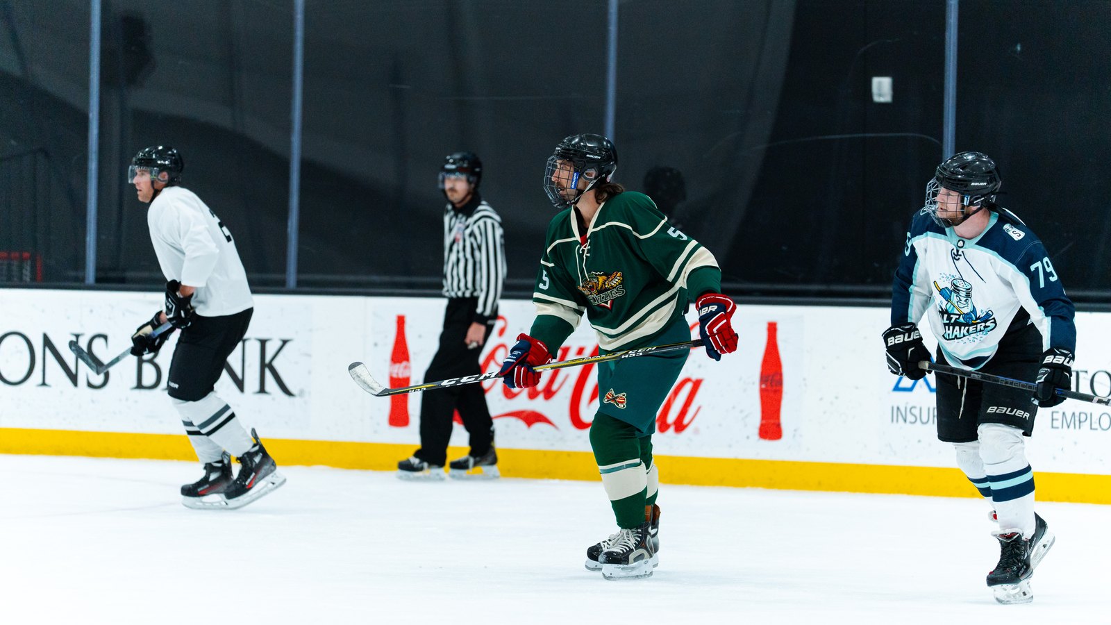 Two beer league hockey teams in home and away jerseys lined up on Utah ice